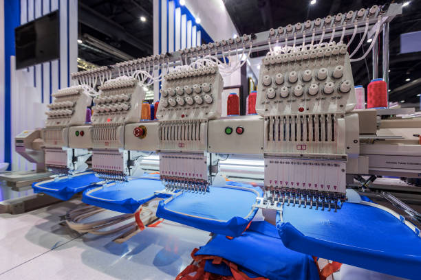 Textile - Professional and industrial embroidery machine. Machine embroidery is an embroidery process whereby a sewing machine or embroidery machine is used to create patterns on textiles.