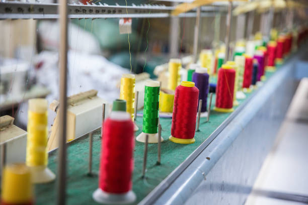 Spools of cotton thread on a textile embroidery machine in Myanmar. Photographer: Taylor Weidman/Bloomberg