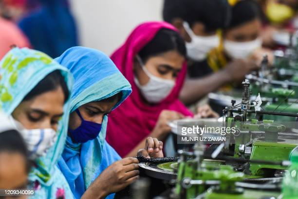 Labourers work in a garment factory during a government-imposed lockdown as a preventative measure against the spread of the COVID-19 coronavirus in Asulia on April 7, 2020. (Photo by Munir UZ ZAMAN / AFP) (Photo by MUNIR UZ ZAMAN/AFP via Getty Images)