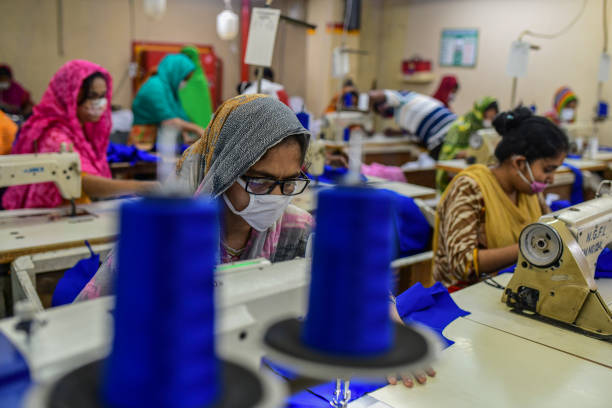 DHAKA, BANGLADESH - 2020/05/03: Labourers wearing face masks as a preventive measure work at a garment factory during the lockdown.
New Generation Fashion Limited workers resume on duty as factories reopen after the government eased the restrictions amid concerns over coronavirus disease (COVID-19) outbreak in Dhaka. (Photo by Zabed Hasnain Chowdhury/SOPA Images/LightRocket via Getty Images)